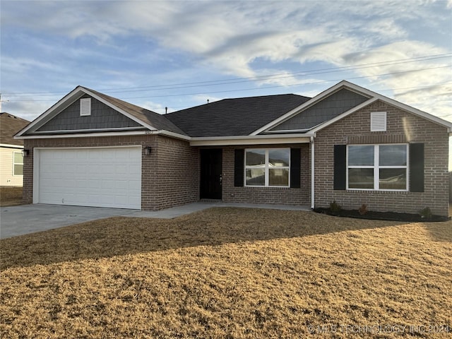 single story home featuring a garage and a front yard