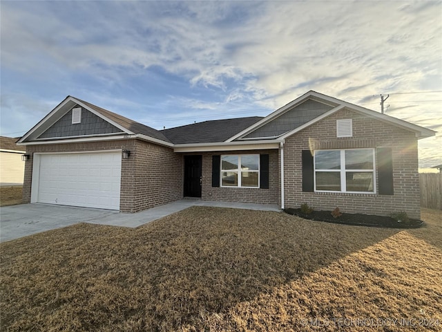 ranch-style house with a front yard and a garage