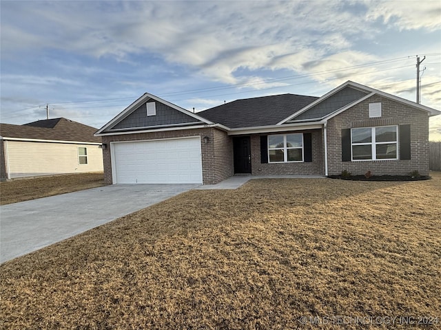 ranch-style home with a front lawn and a garage