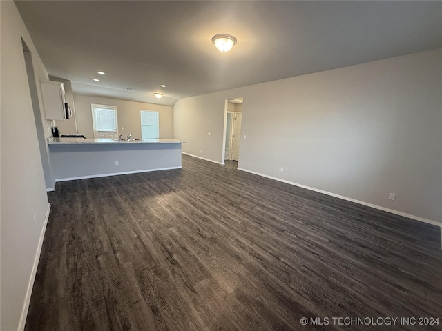 unfurnished living room featuring dark hardwood / wood-style floors