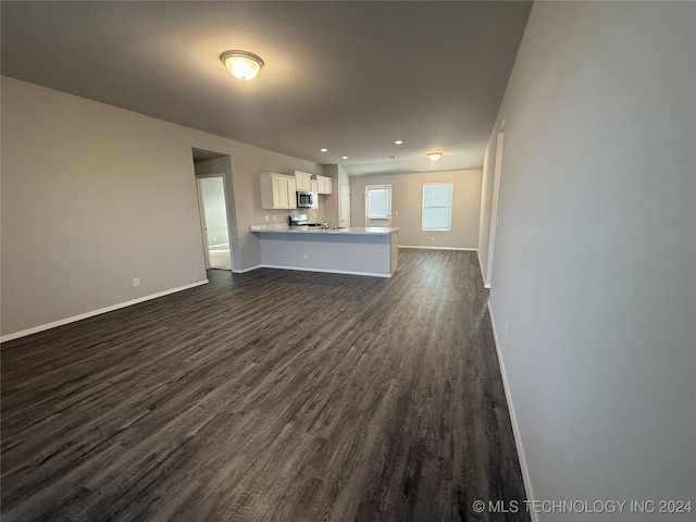 unfurnished living room with dark hardwood / wood-style floors