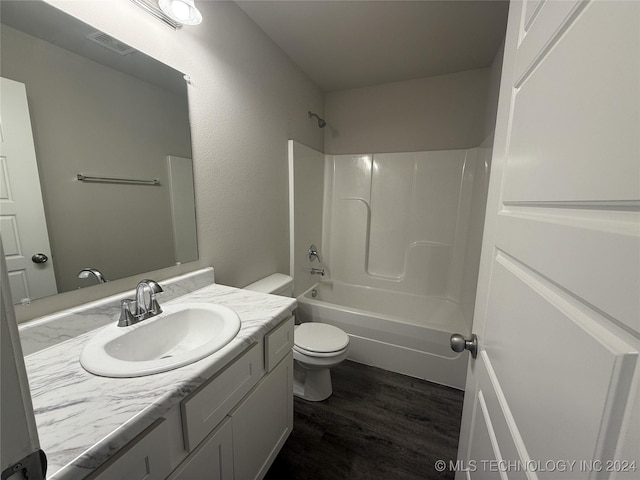 full bathroom with wood-type flooring, vanity, toilet, and tub / shower combination