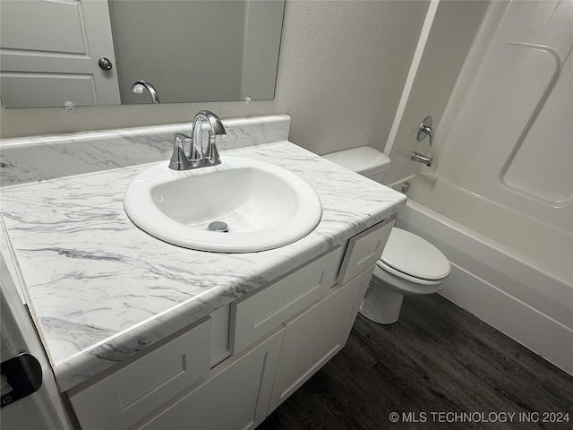 full bathroom featuring vanity, wood-type flooring, bathtub / shower combination, and toilet