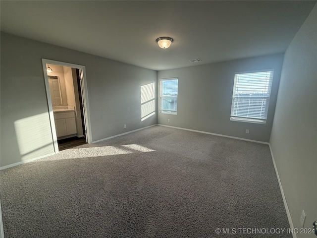 carpeted empty room featuring plenty of natural light