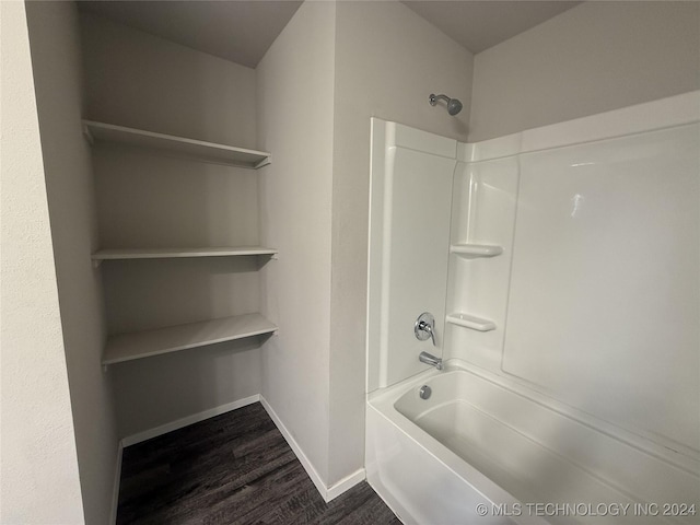 bathroom with hardwood / wood-style flooring and shower / bathtub combination