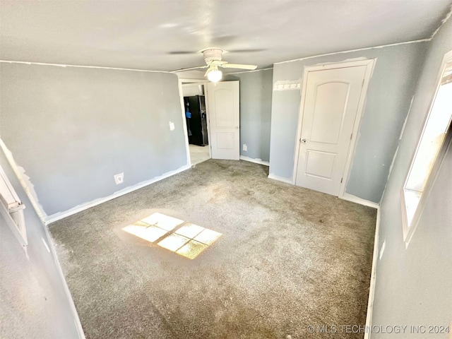 carpeted empty room with ceiling fan