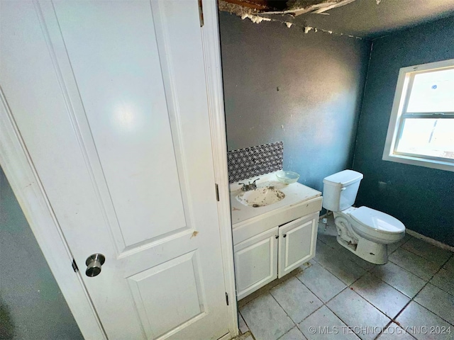 bathroom with tile patterned flooring, vanity, and toilet