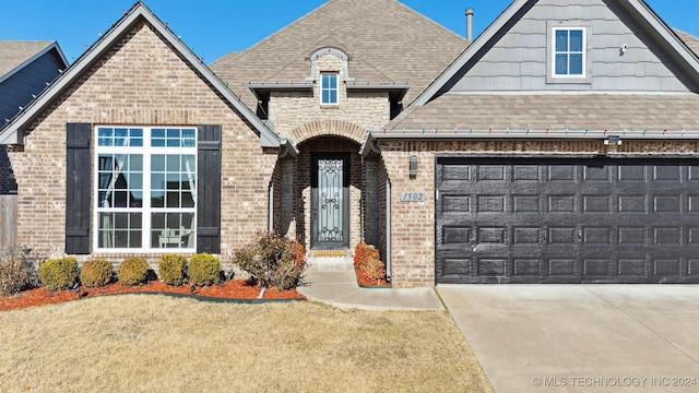 view of front of home with a front yard and a garage