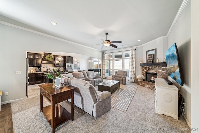 carpeted living room with crown molding, a fireplace, and ceiling fan with notable chandelier