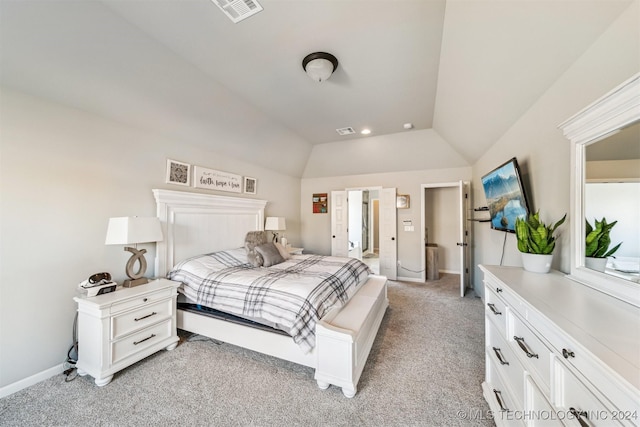 carpeted bedroom with lofted ceiling