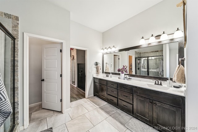 bathroom with a shower with door and vanity