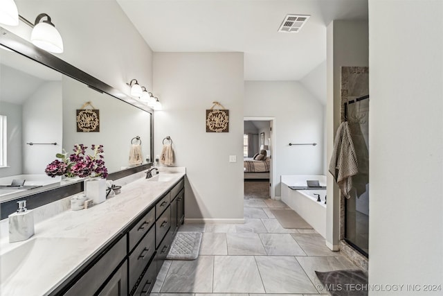 bathroom featuring plus walk in shower, vanity, and lofted ceiling