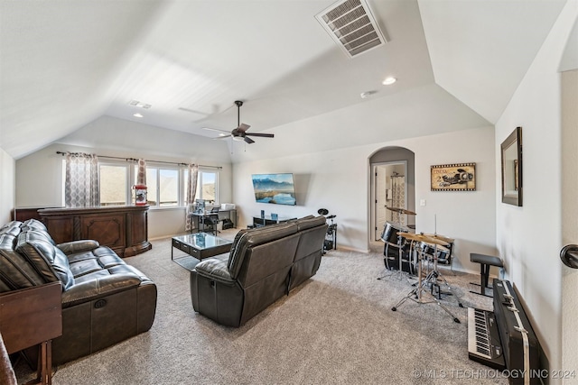 carpeted living room with ceiling fan and lofted ceiling