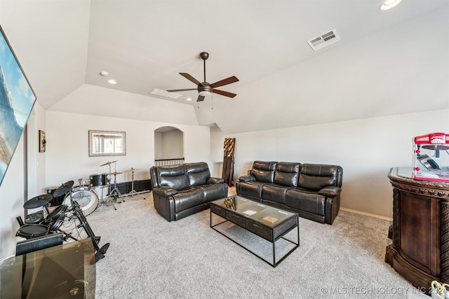 carpeted living room with ceiling fan and vaulted ceiling