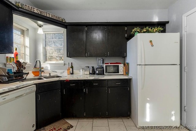 kitchen featuring white appliances and sink