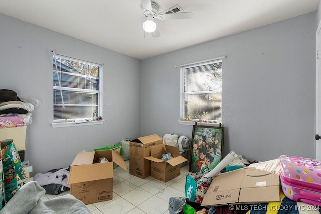 bedroom with ceiling fan and light tile patterned flooring