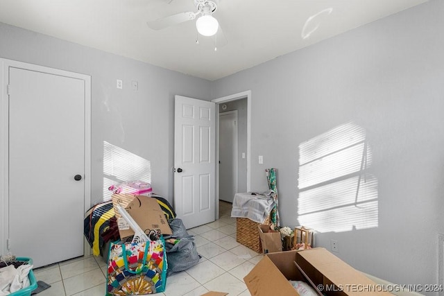 bedroom with ceiling fan and light tile patterned flooring