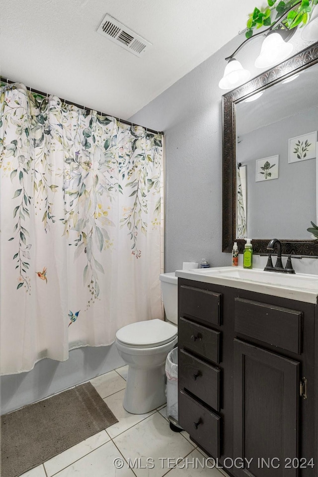 full bathroom featuring tile patterned flooring, shower / bath combination with curtain, vanity, and toilet