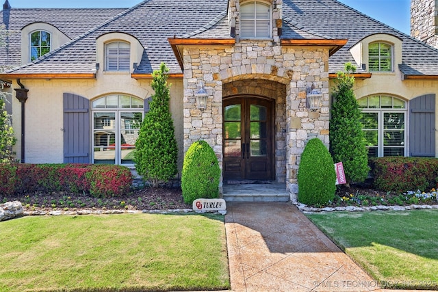 10616 S Forest Ave, Jenks, OK 74037 - entrance to property with a shingled roof, french doors, a yard, and stone siding