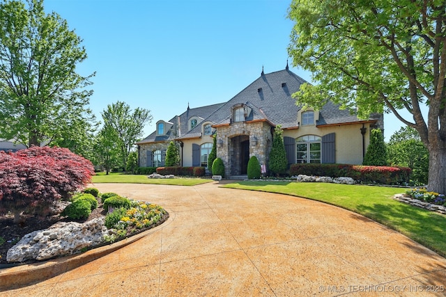 10616 S Forest Ave, Jenks, OK 74037 - french country home with a front yard, curved driveway, stone siding, and stucco siding
