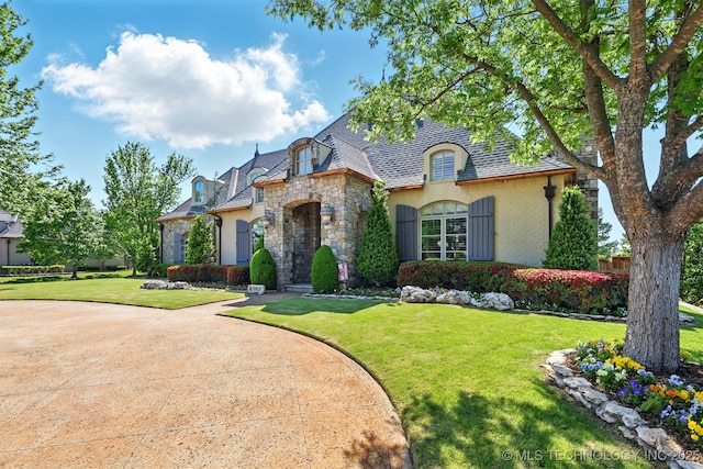 10616 S Forest Ave, Jenks, OK 74037 - french country style house featuring stucco siding, a high end roof, stone siding, and a front lawn