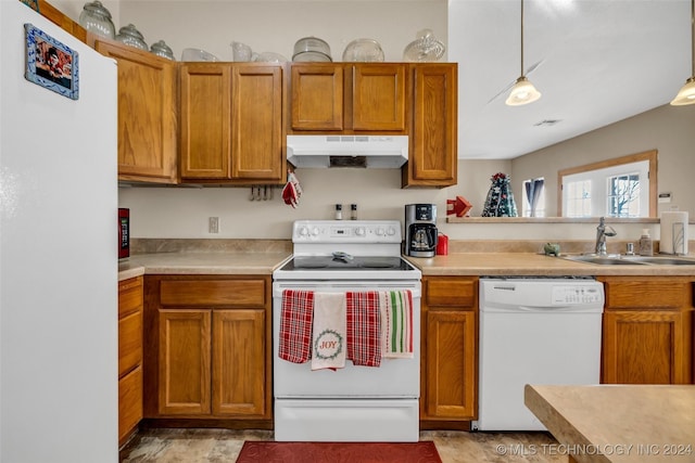 kitchen with pendant lighting, white appliances, and sink