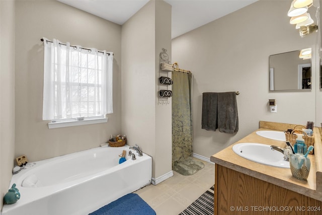 bathroom with a washtub and vanity