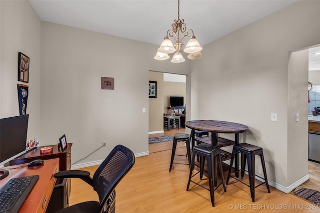 dining area featuring a notable chandelier and light hardwood / wood-style floors