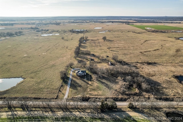 birds eye view of property with a rural view and a water view