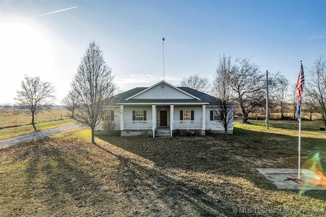 view of front of house with covered porch and a front yard