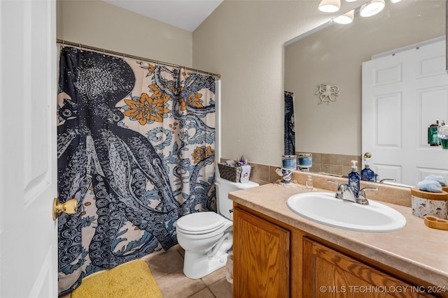 bathroom featuring tile patterned flooring, vanity, and toilet