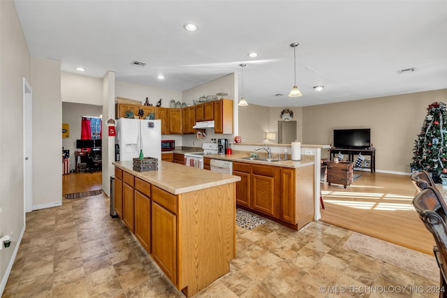 kitchen featuring sink, pendant lighting, white appliances, light hardwood / wood-style floors, and a kitchen island