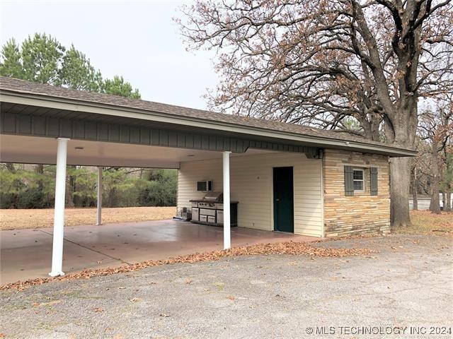 view of parking / parking lot featuring a carport