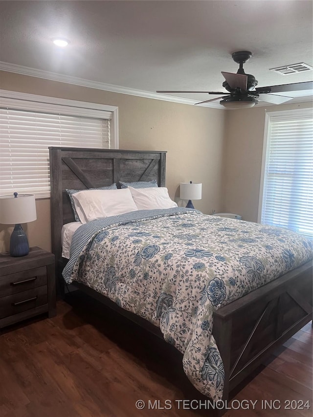 bedroom featuring dark hardwood / wood-style floors, ceiling fan, and crown molding