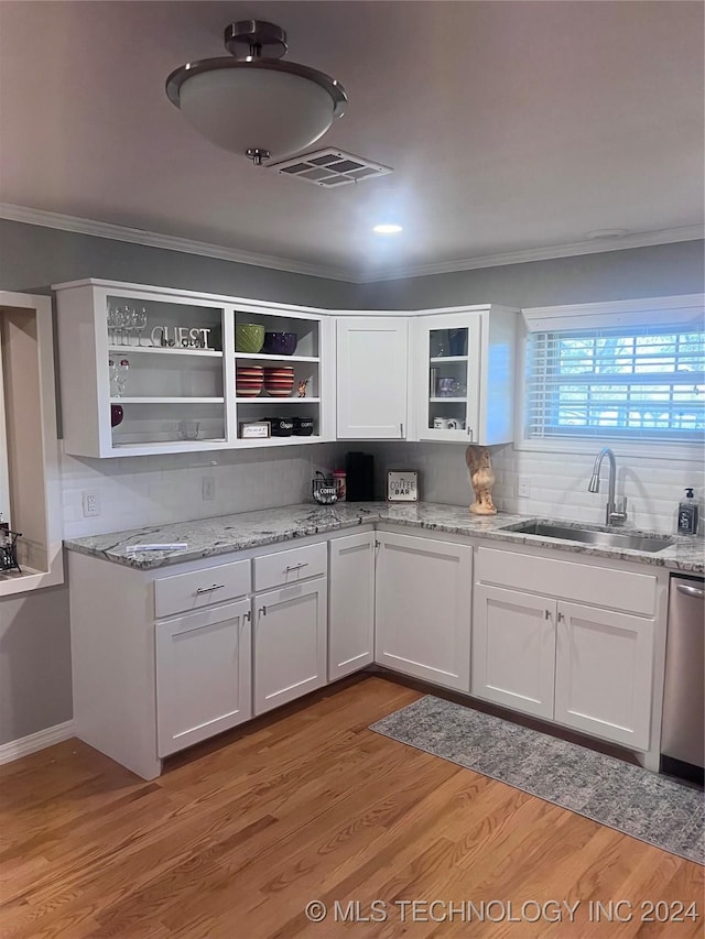 kitchen with white cabinetry, sink, and light wood-type flooring