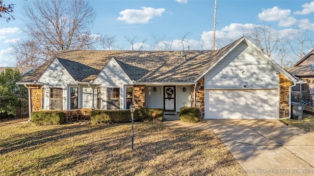 ranch-style house featuring a front yard and a garage