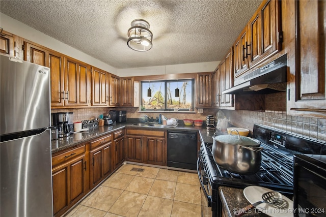 kitchen with decorative backsplash, a textured ceiling, sink, black appliances, and light tile patterned floors