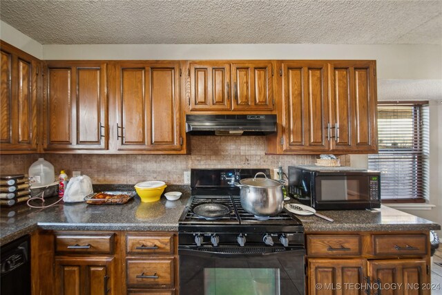 kitchen with tasteful backsplash, black appliances, and a textured ceiling