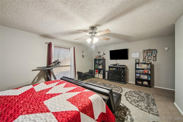 carpeted bedroom featuring ceiling fan and a textured ceiling