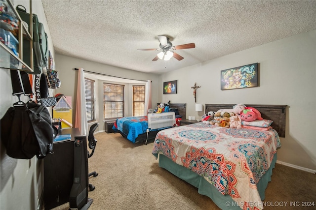 carpeted bedroom featuring a textured ceiling and ceiling fan