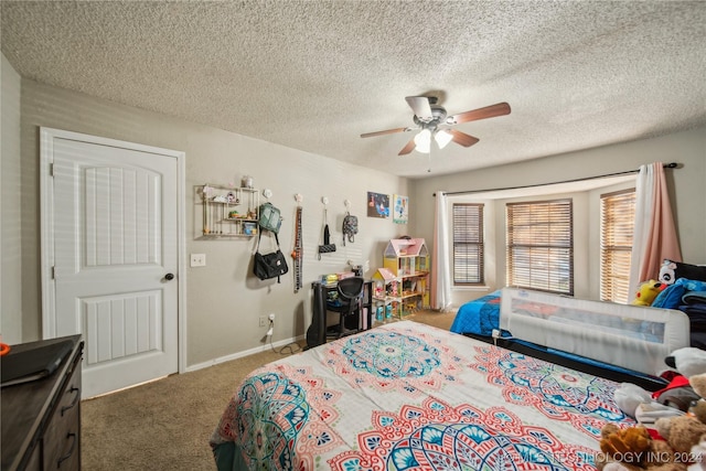 bedroom featuring dark colored carpet, a textured ceiling, and ceiling fan