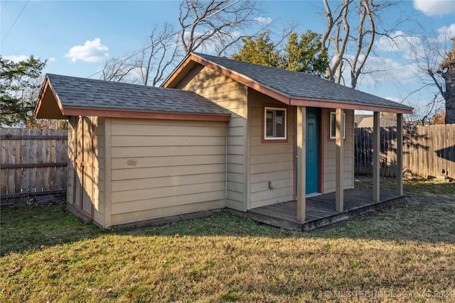 view of outbuilding with a yard