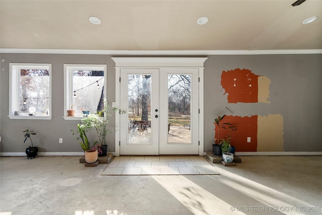 doorway to outside with crown molding and french doors