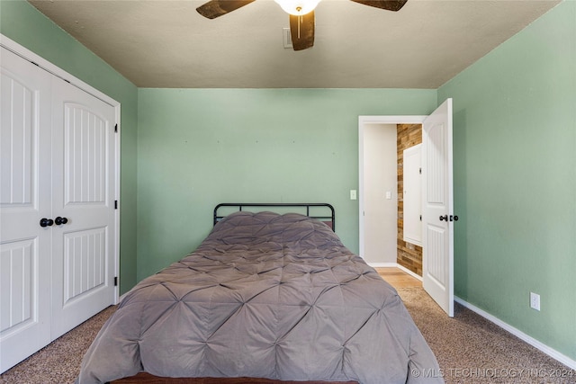 bedroom with light carpet, a closet, and ceiling fan