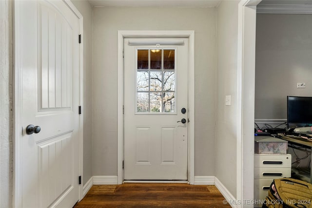 doorway with dark hardwood / wood-style floors and ornamental molding