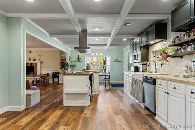 kitchen featuring wood counters, coffered ceiling, white cabinets, stainless steel dishwasher, and beamed ceiling