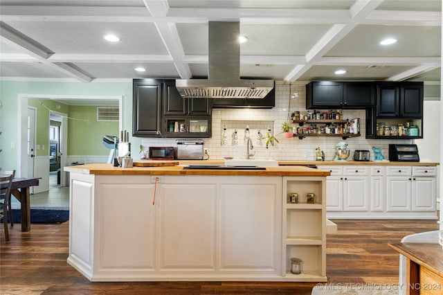 kitchen with coffered ceiling, dark wood-type flooring, exhaust hood, butcher block countertops, and white cabinetry