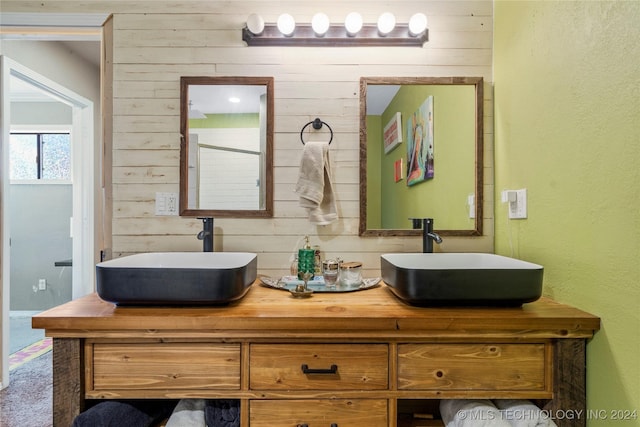 bathroom with vanity and wooden walls