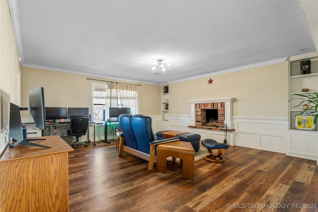 office area with built in shelves, crown molding, dark wood-type flooring, and a brick fireplace