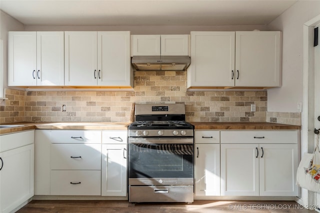 kitchen featuring sink, stainless steel gas stove, white cabinetry, and backsplash